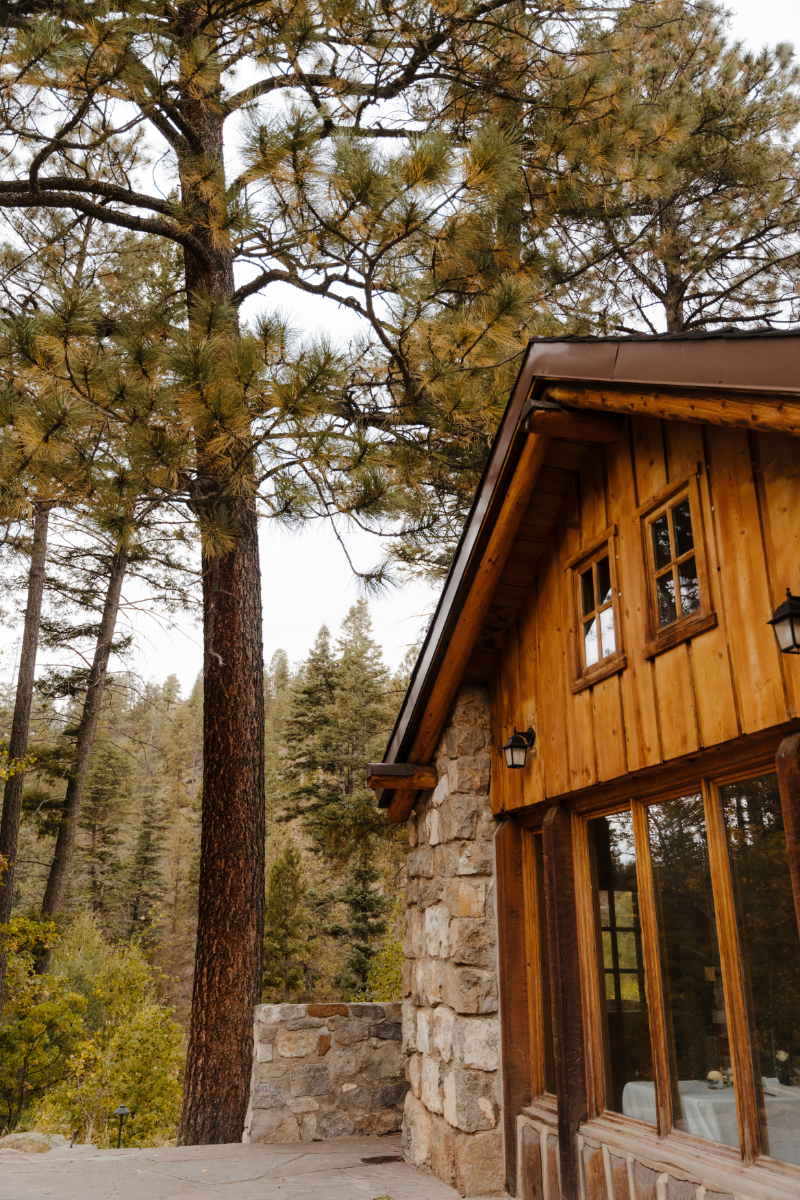 Beautiful outdoor wedding venues in New Mexico featuring cabin on-site in wooded area.