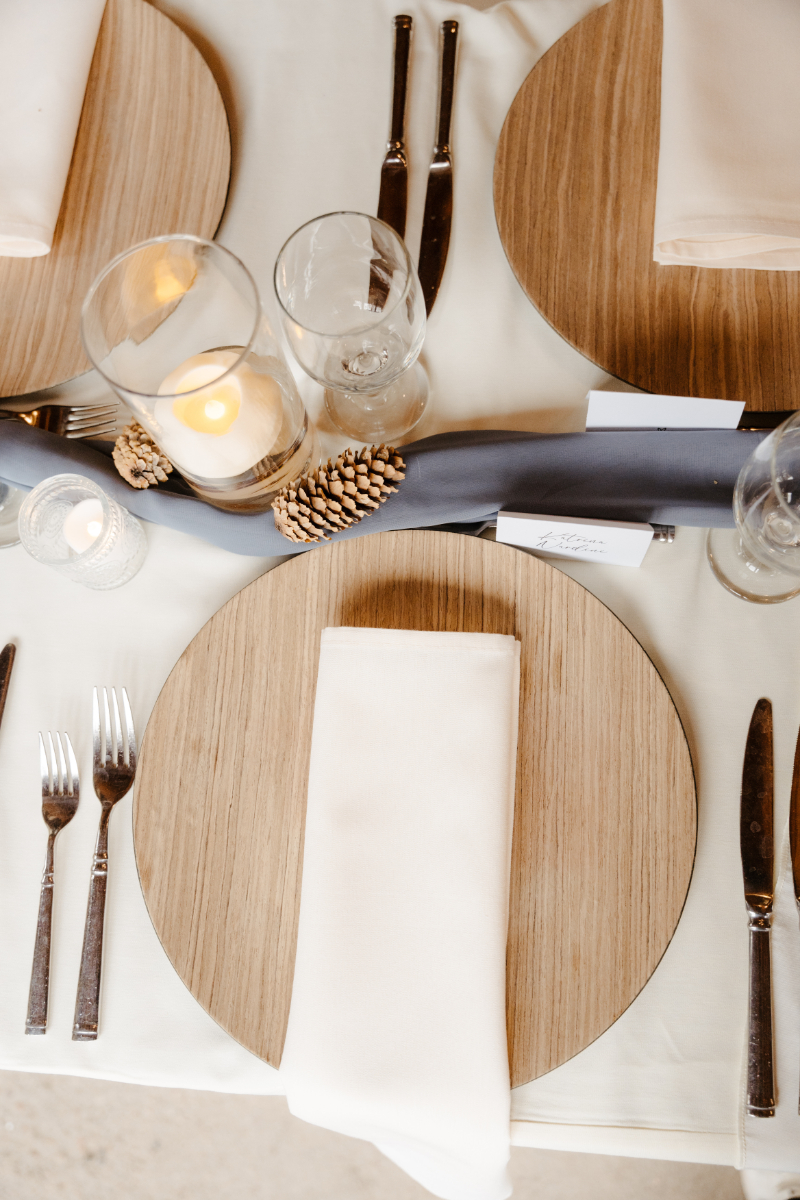 Wedding tablescape with wooden charger, and blue details.