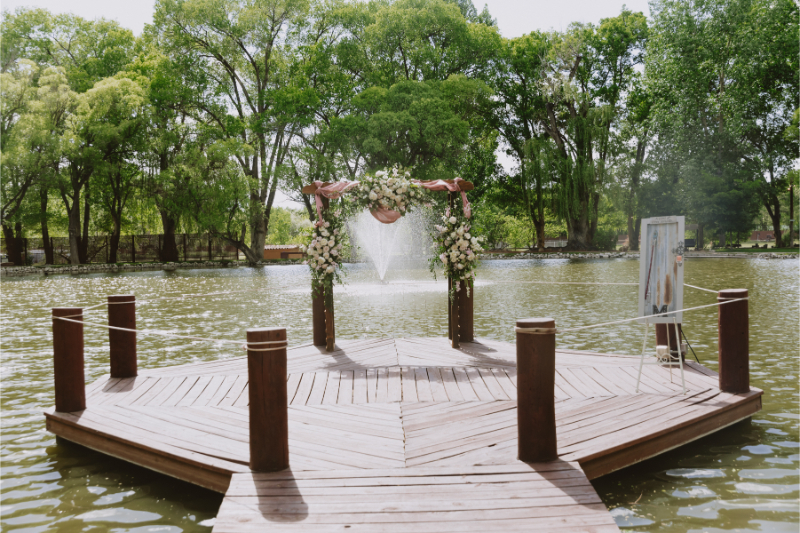Wedding ceremony arch in middle of dock on Nashville wedding venues on-site pond.