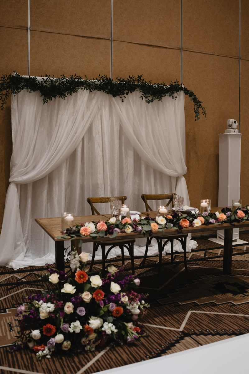 Sweet heart table for desert botanical garden wedding in New Mexico decorated with florals and floating candles.