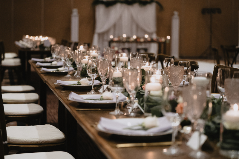 Long rectangular table set with dinner and glassware for desert botanical garden wedding reception.