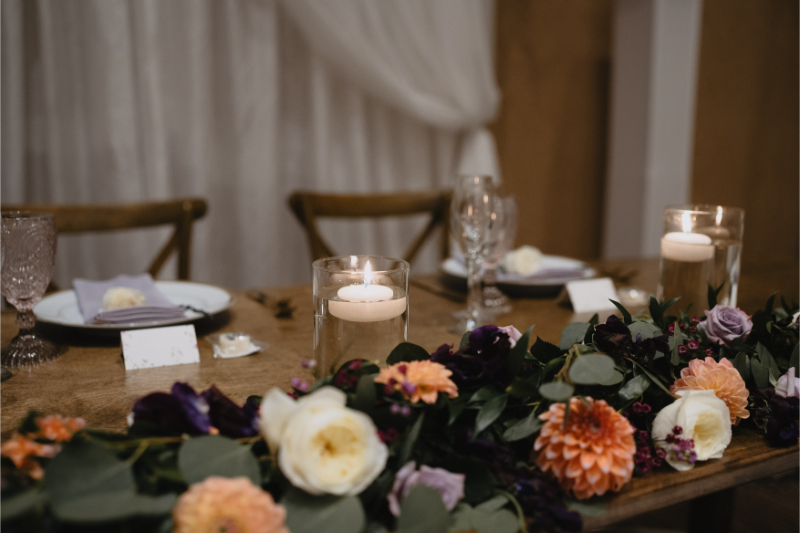 Sweet heart table for desert botanical garden wedding in New Mexico decorated with florals and floating candles.