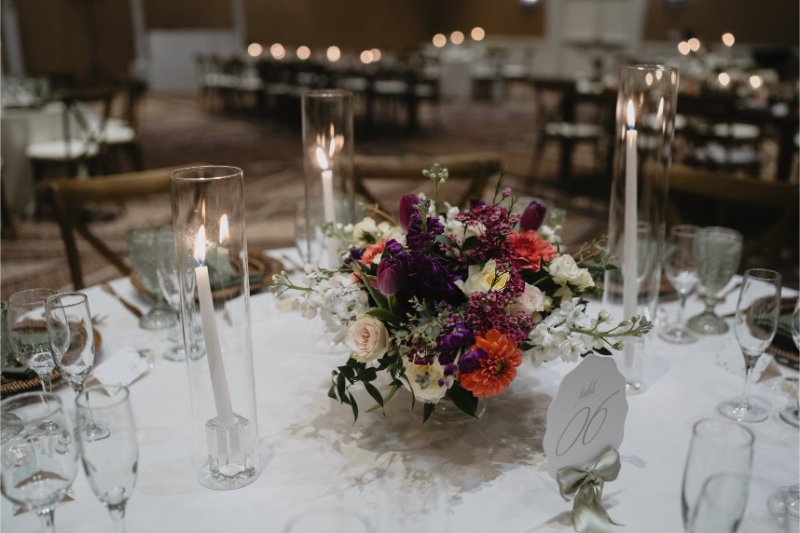 Low floral arrangement sitting in middle of table for desert botanical garden wedding reception.