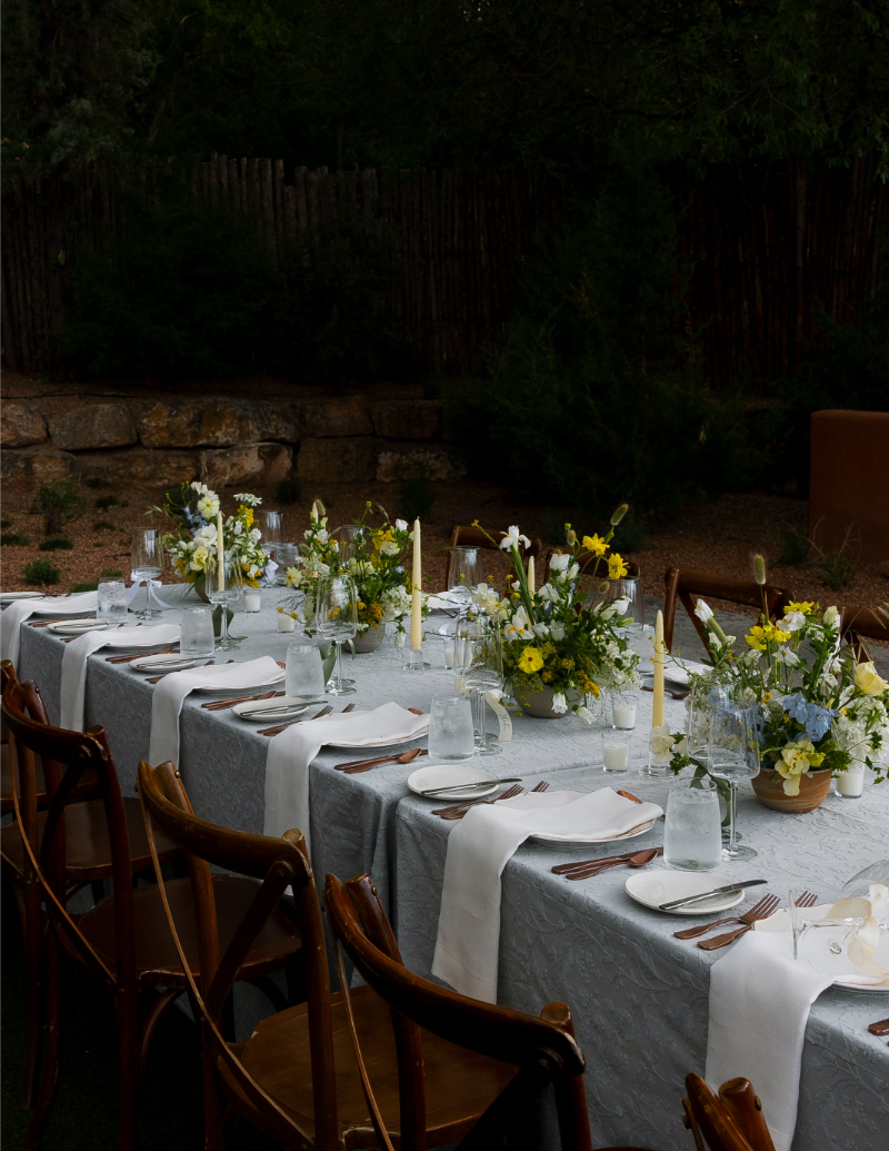 Reception table decorated with small arrangement of fall florals.