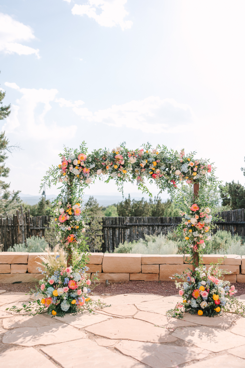 Colorful floral arch perfect for wedding arch ideas.