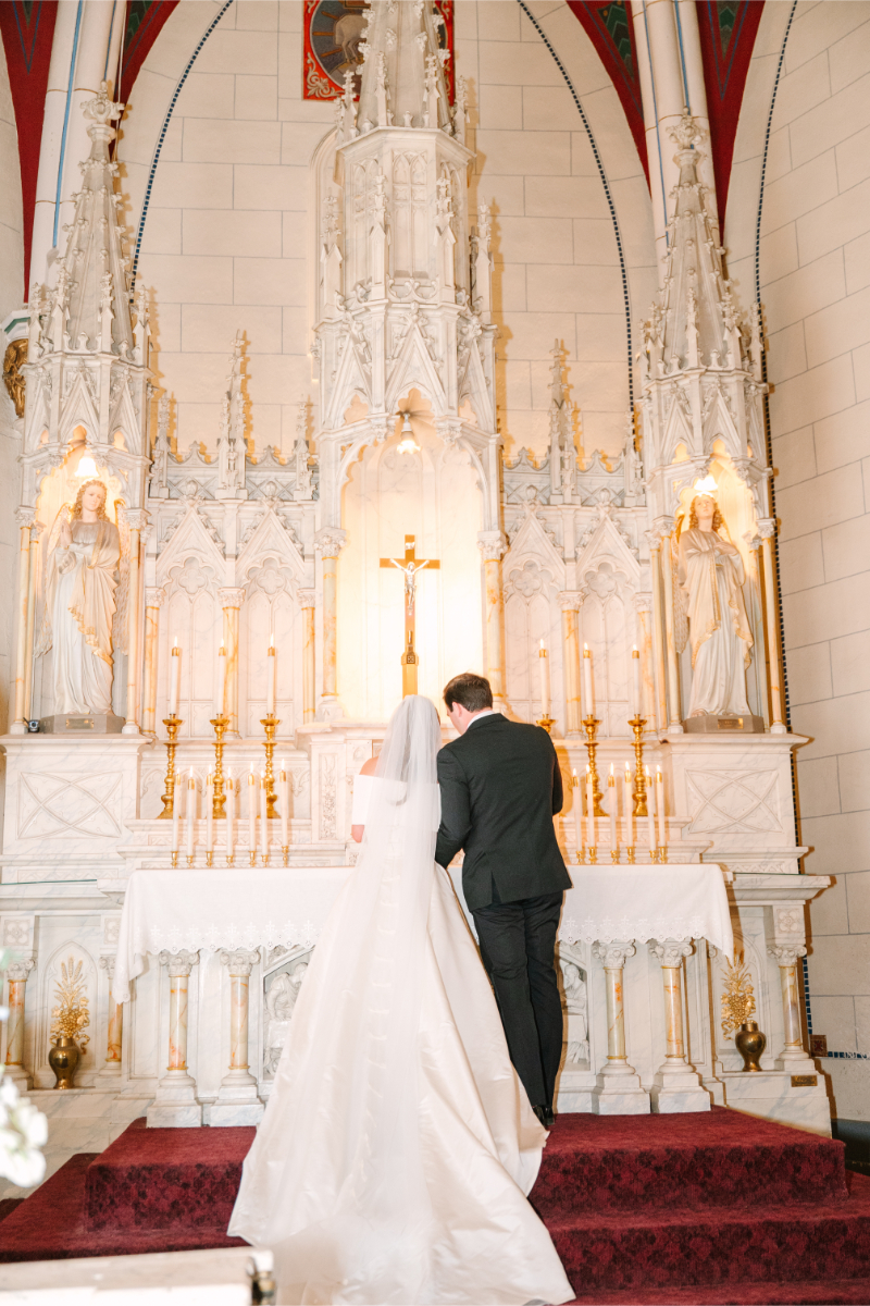 Bride and groom lighting unity candles in a church, one of the wedding ceremony ideas they definitely wanted to do.