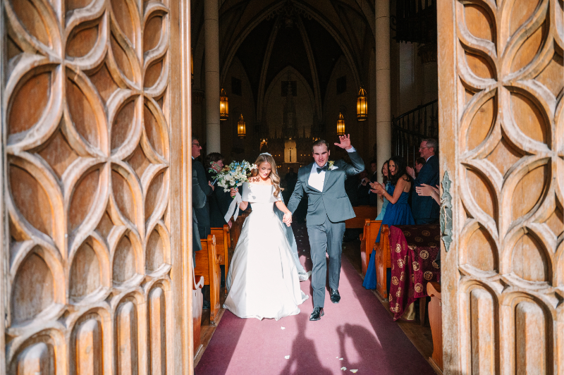Bride and groom walk out of church together after their wedding ceremony ideas all played out.