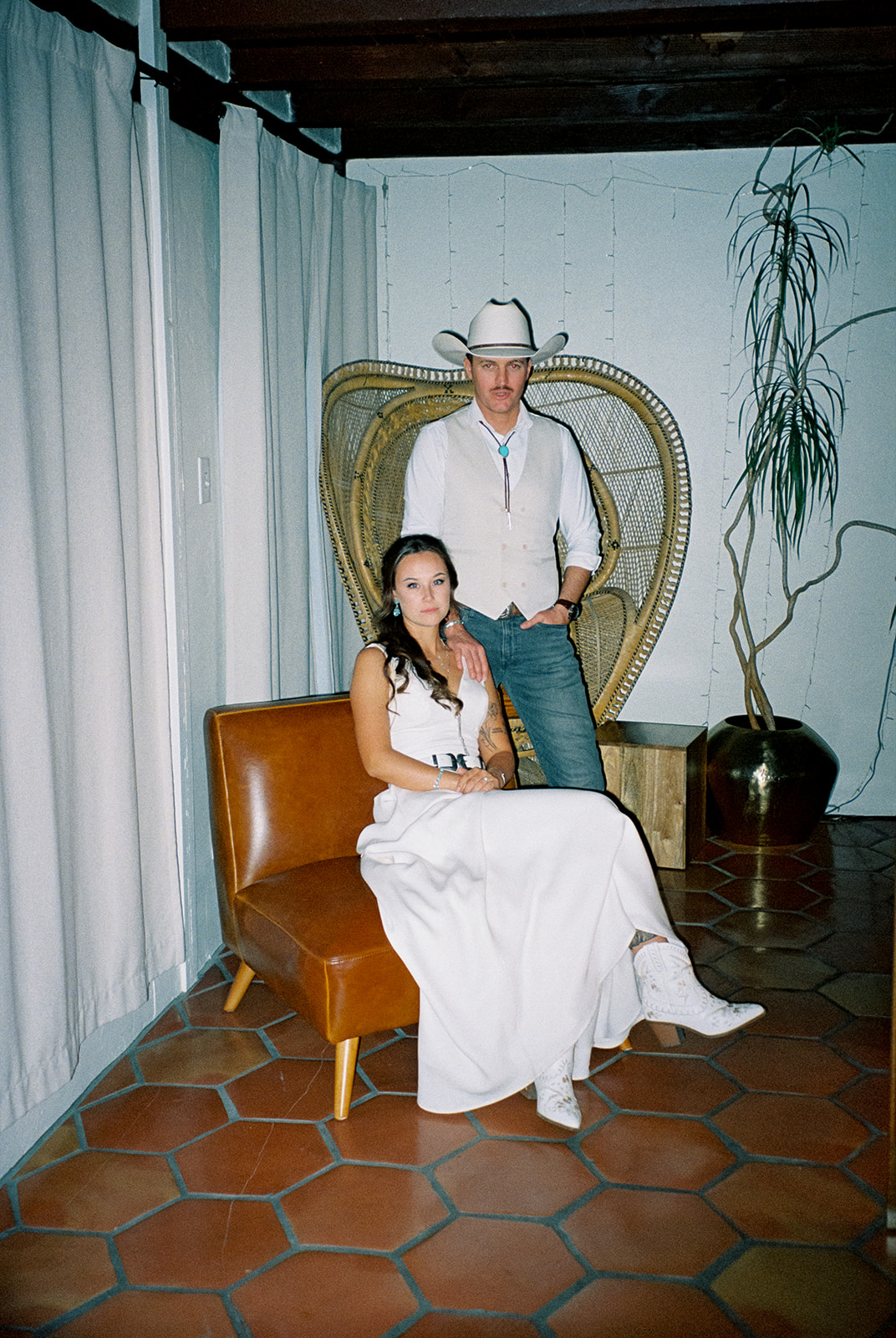 Bride and groom pose for portraits during western wedding day.