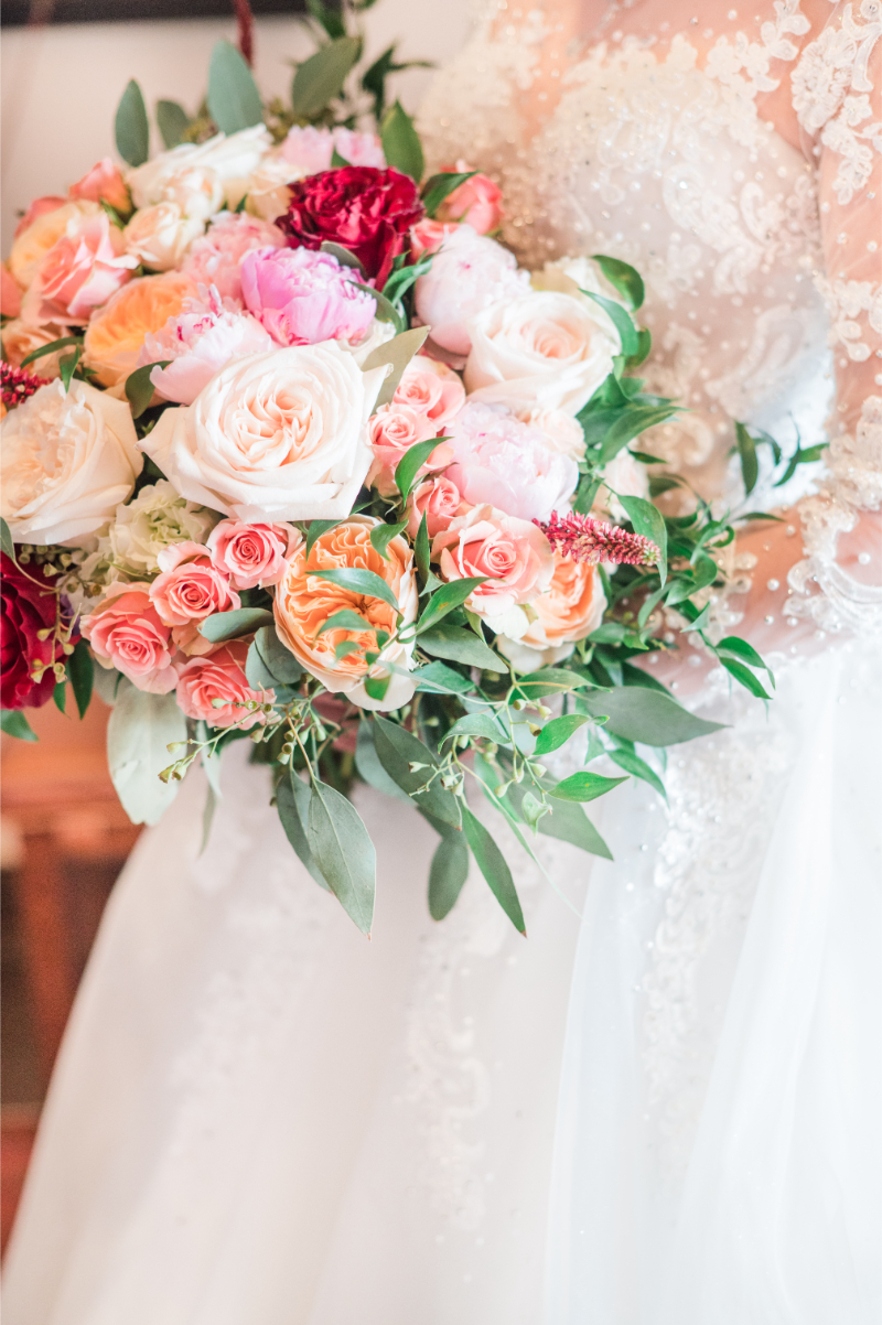 Pink and green wedding bouquet filled with roses and greenery for a New Mexico bride.